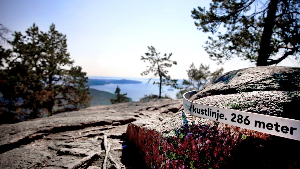 Picture on top of the coastline with a ribbon telling people they are 286 meters above sea level.